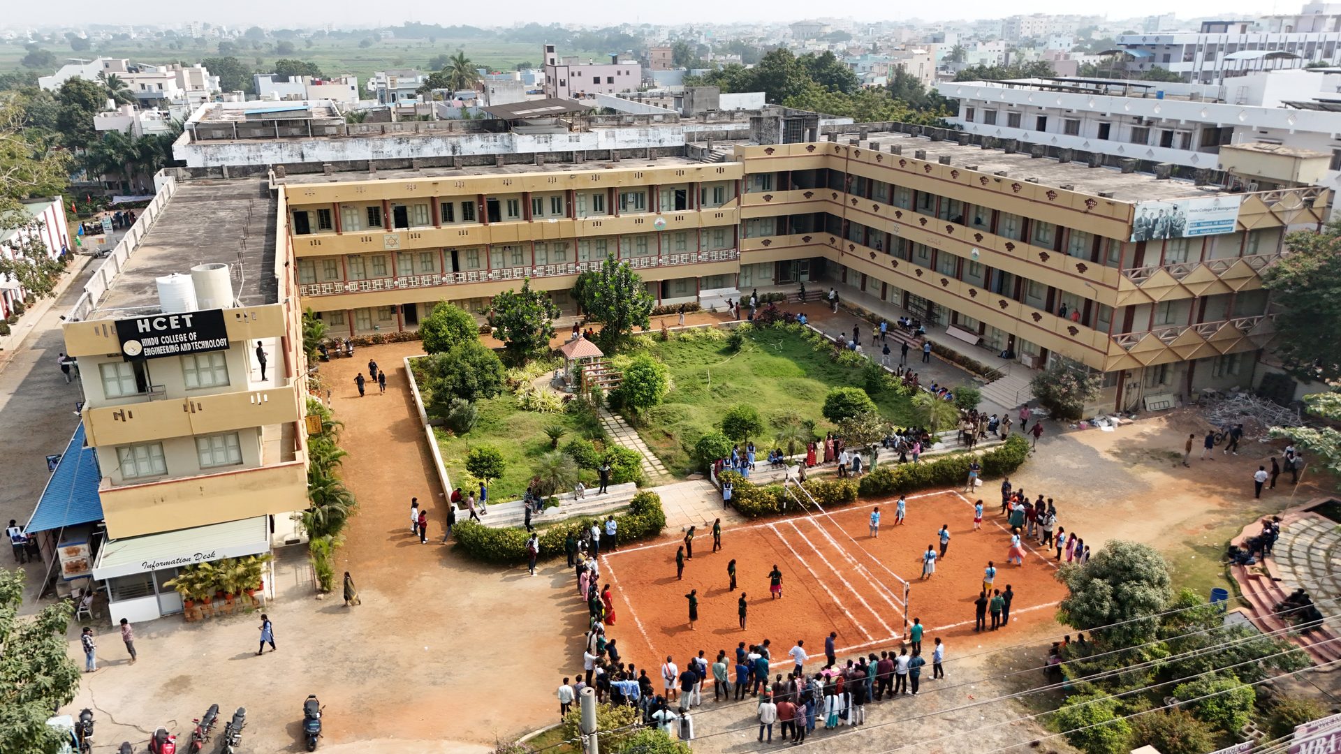 Aerial view of the HCET campus courtyard with students playing volleyball